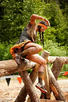 Obstacle Prints: A mud covered woman vaults an obstacle at the Whistler Vancouver Tough Mudder event