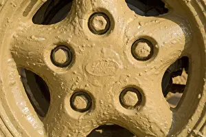 Motoring Prints: The muddy wheel of a Land Rover Defender 90 after driving through a flooded road