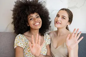 Home Interior Prints: Multi-ethnic female friends waving at home