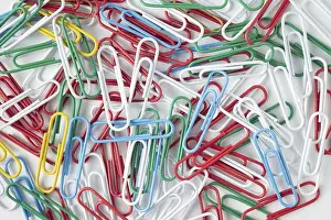 Against White Background Prints: Multicolored paper clips on a white background, texture background