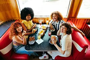 Hanging Out Prints: Multiethnic group of friends having meal at 80s vintage diner restaurant - Multiracial young people bonding