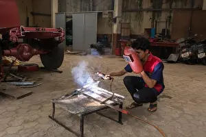 Repairman Prints: Mumbai, India - July 8, 2018 - Indian boys learning about welding in vocational school