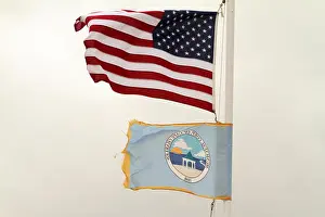American Flag Prints: The municipal flag and the U.S. flag flying in Cape Charles, VA, USA