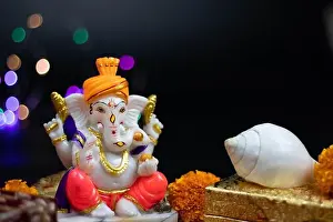 Murti or Moorti Of Hindu God Lord Ganesha Ganpati Bappa Morya In Orange Pagdi For Worship On Diwali Puja New Year Deepawali Ganesh Chaturthi Or Shubh
