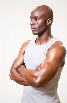 Bodybuilding Prints: Serious muscular man with arms crossed looking away