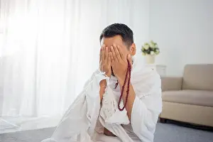 Muslims Prints: Muslim man praying in white traditional clothes