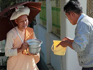 Receiving Prints: Myanmar, Burma, Nyaungshwe, buddhist nun receiving alms of rice, Shan State