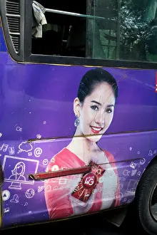Burma Prints: Myanmar (Burma). Yangon. Public bus painted with an advert for a 4G mobile phone