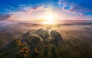 Mystical morning river, the sun's rays shine through the fog