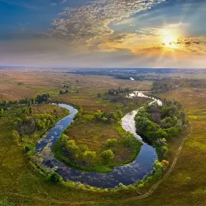 Mystical morning river, the sun's rays shine through the fog