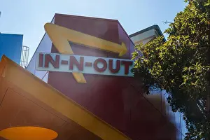 Chain Store Prints: In N Out Burger iconic sign, red background, yellow arrow, building mount in San Francisco