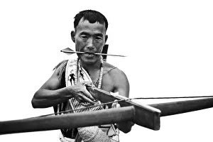 Indigenous Culture Prints: Naga tribal warrior holding a cross bow, Hornbill Festival, Kohima, Nagaland, India
