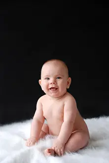 Offspring Prints: Naked baby sitting up with big smile