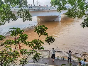 Rainstorm Prints: NANNING, CHINA - SEPTEMBER 11, 2024 - Citizens watch flood waters at Yongjiang River No