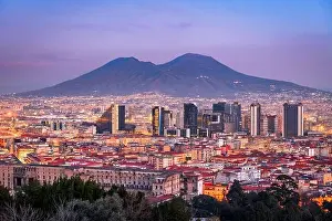 Naples, Italy with the financial district skyline under Mt. Vesuvius at twilight