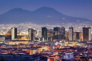 Naples, Italy with the financial district skyline under Mt. Vesuvius at twilight