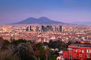 Naples, Italy with the financial district skyline under Mt. Vesuvius at twilight