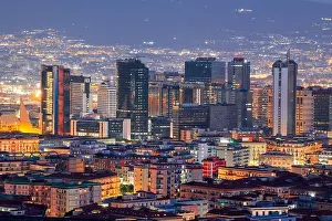 Naples, Italy with the financial district skyline under Mt. Vesuvius at twilight