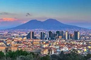 Naples, Italy with the financial district skyline under Mt. Vesuvius at twilight