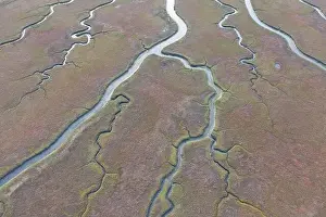 Narrow channels meander through a beautiful estuary in Central California. Estuaries form when freshwater runoff meets and mixes with seawater