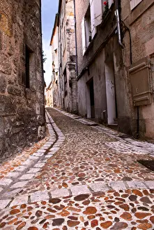 Paved Prints: Narrow medieval street in town of Perigueux Perigord France