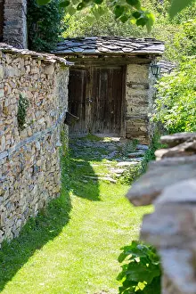 Stone Walls Prints: Narrow street covered with grass between old stone walls