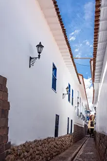 Cusco Prints: Narrow street with white colonial buildings in the center of Cuzco, Peru