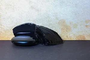 Geological Formation Prints: Natural and shiny Obsidian stones illustrating surface differences used in gemology and earth science education