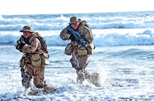 Us Navy Prints: US Navy SEALs practice beach landings during combat training