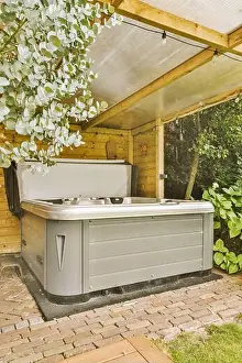 Seat Prints: Neat paved patio with sitting area and small garden near wooden fence