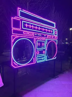 Modern Design Prints: Neon boombox light installation glowing at night in Mellat Park
