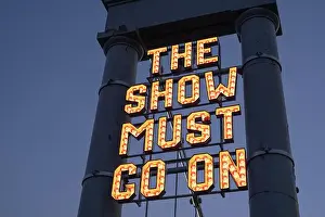Neon sign The Show Must Go On installed by The Stove Network over the Dumfries Suspension Bridge