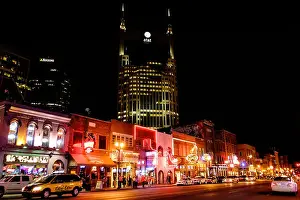 Nashville Tennessee Prints: Neon signs illuminate Broadway Street at night in Downtown Nashville, Tennessee