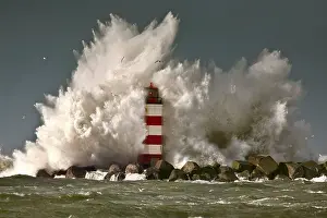 Smash Prints: The Netherlands, IJmuiden, Storm. Waves crash against lighthouse or beacon