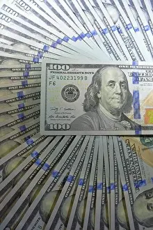 new hundred dollar bills American $100 USD cash money fanned out in a circle filling the frame with one bill laid