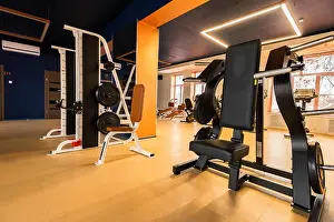 Barbell Prints: New fitness machines in modern gym interior