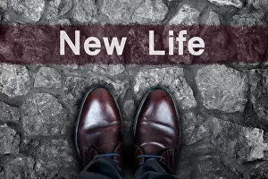 Begin Prints: New Life message on asphalt and business shoes
