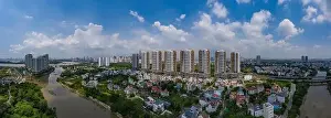 new luxury housing development of eight high rise towers located on a river in southest asia