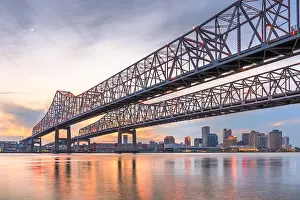 New Orleans, Louisiana, USA at Crescent City Connection Bridge over the Mississippi River at dusk