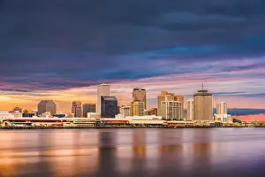 New Orleans, Louisiana, USA downtown city skyline on the Mississippi River at sunset