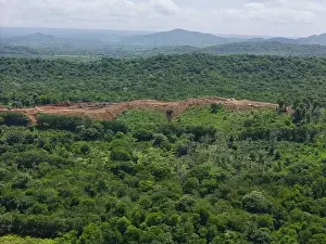 Quarrying Prints: New quarry development in green nature forest aerial drone view
