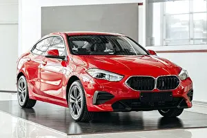 Showroom Prints: New red luxury car on a car presentation in showroom