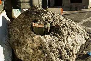 Cleanliness Prints: A New York City Dept. of Sanitation public trash basket in the neighborhood of Chelsea is submerged in dirty snow