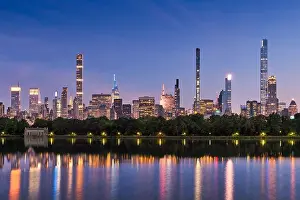 Nightfall Prints: New York City skyline at dusk with reflections of Billionaires Row supertall skyscrapers in Central Park Reservoir
