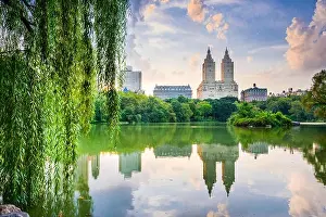 New York City, USA at the Central Park Lake and Upper West Side skyline