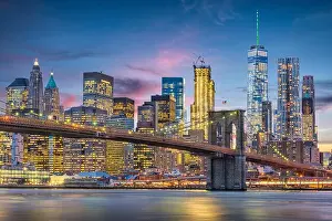 New York City, USA skyline on the East River with Brooklyn Bridge at dusk