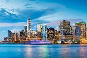 New York, New York, USA downtown city skyline at dusk on the harbor