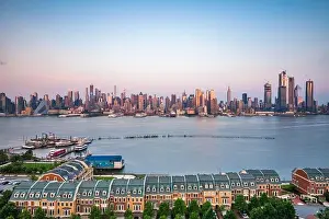 New York, New York, USA downtown city skyline on the Hudson River at dusk