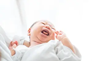 Childcare Prints: Newborn baby (0 years 0 months) being held in arms