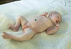Bedroom Prints: Newborn baby girl lies on the bed